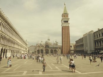 People walking in front of historical building