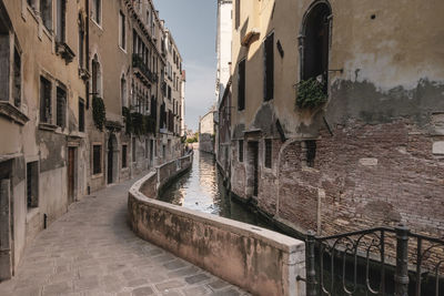 Alley amidst buildings in city. venice, italy