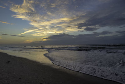 Scenic view of beach against sky during sunset