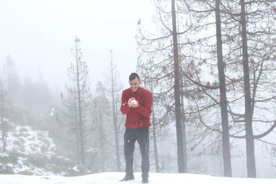 Man standing on snow covered land