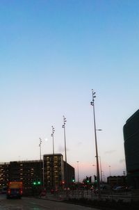 Cars on road against sky in city