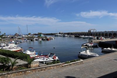 Boats moored at harbor in city