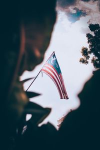 Low angle view of flag against sky