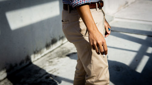 Low section of man standing on street