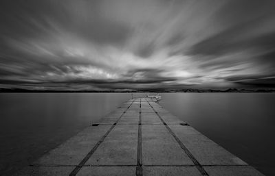 Pier over sea against sky