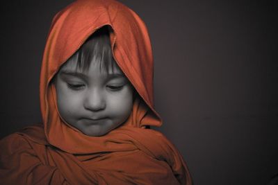 Portrait of boy against black background