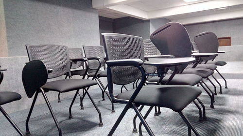 Empty chairs and table in classroom