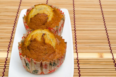 High angle view of muffins in plate on table