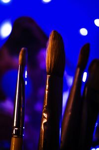 Close-up of make-up brushes in illuminated room