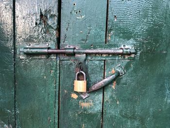 Close-up of padlocks on metal door