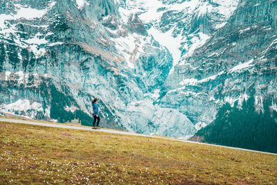 Woman looking at snowcapped mountain