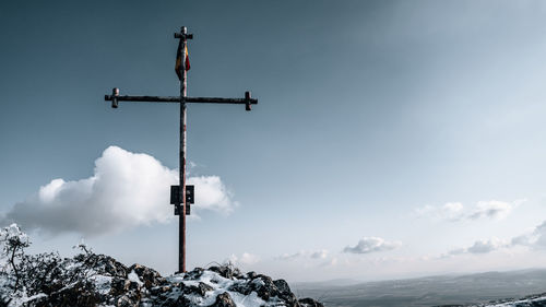 Low angle view of cross with romanian flag on the top of cheiile turzii