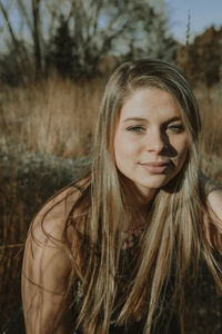 Portrait of young woman against plants