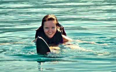 Portrait of happy woman waterskiing in sea