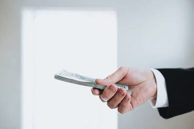 Close-up of hand holding paper