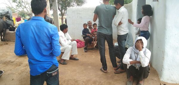 Rear view of people standing outdoors