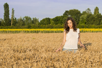 Beautiful young woman standing in field