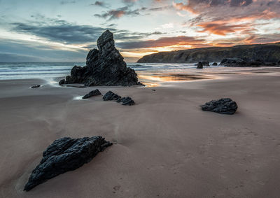 Scenic view of beach against sky during sunset