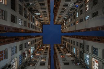 Directly below shot of residential buildings against sky at night