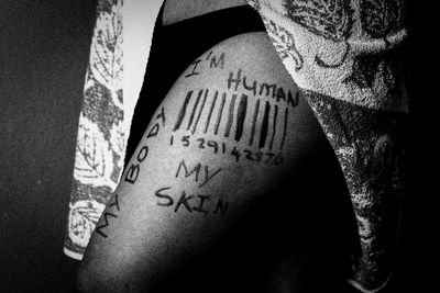 Close-up of human hand with text