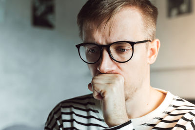 Close-up of young man in deep thoughts