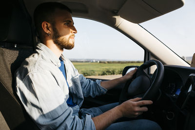 Young man driving van