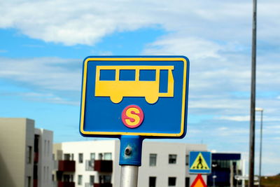 Low angle view of road sign against sky