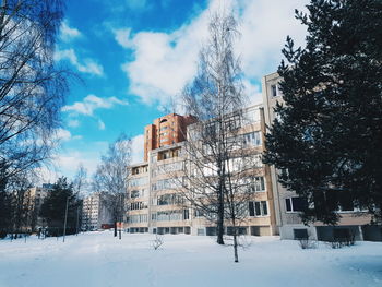 Low angle view of buildings against sky during winter