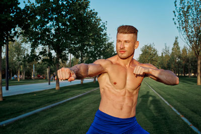 Portrait of young man exercising in park