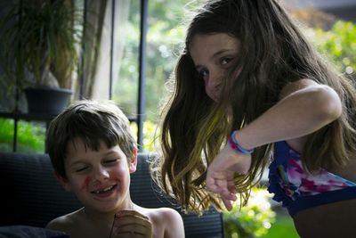 Cheerful siblings playing in yard