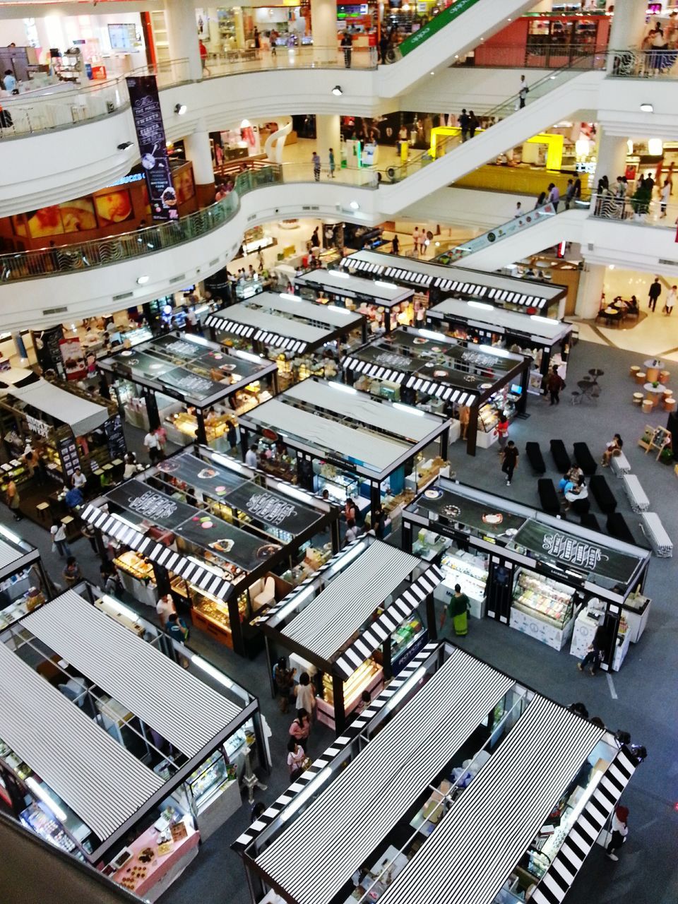 large group of objects, high angle view, abundance, arrangement, retail, variation, market, market stall, in a row, choice, for sale, chair, incidental people, order, shopping, repetition, collection, consumerism, store, day