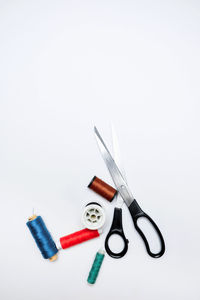 High angle view of tailoring tools like scissors and multi-colored yarns. diy project.