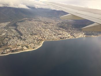 Cropped image of airplane flying over cityscape