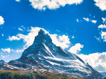 Low angle view of snowcapped mountains against sky