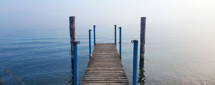 Pier over sea against clear sky