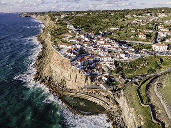 High angle view of buildings by sea