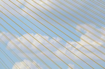 Cloudy sky seen through cables of rama viii bridge