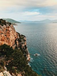 High angle view of rocks by sea against sky