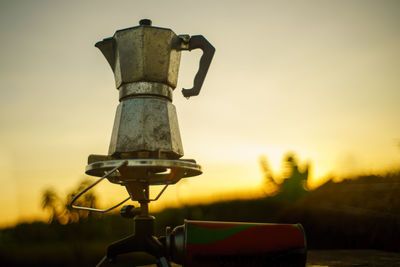 Antique coffee pot on the gas stove for camping when the sun rises in the morning.