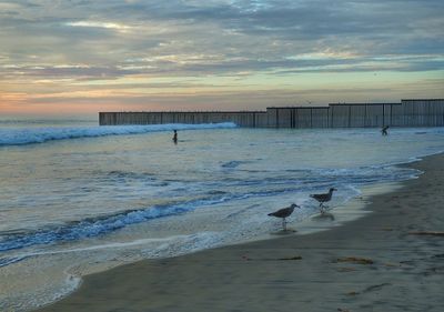 Scenic view of sea against cloudy sky