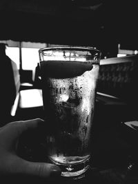 Close-up of hand holding beer glass