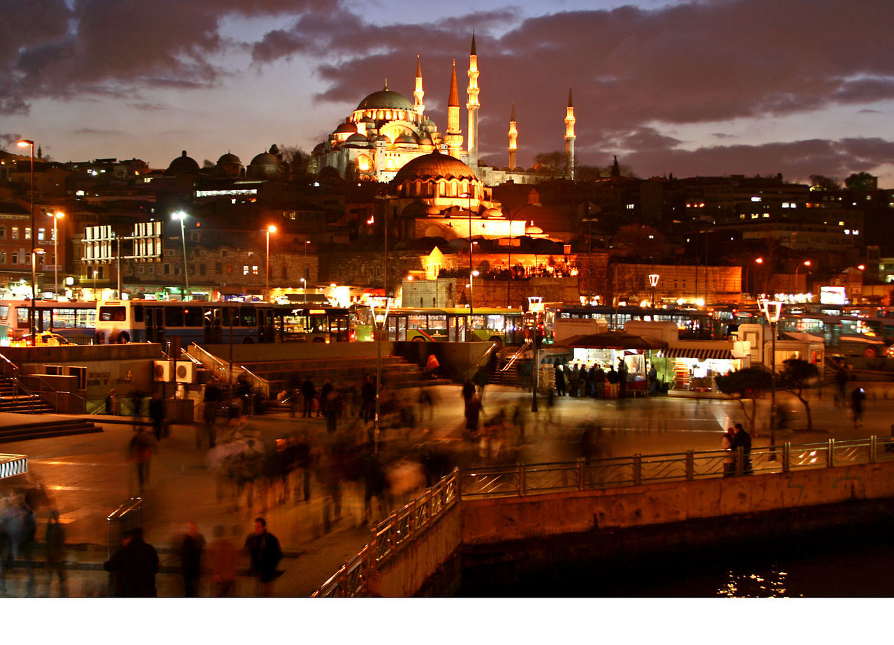 HIGH ANGLE VIEW OF ILLUMINATED CITY AT NIGHT