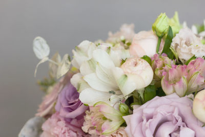 The delicate rustic floral bouquet of rose lilac peony on grey background