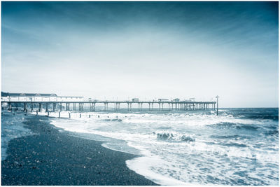 Pier over sea against sky