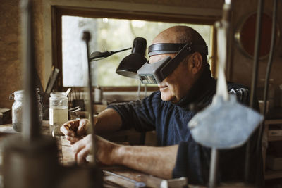 Senior craftsman working in workshop