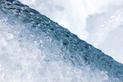 Close-up of frozen sea against sky