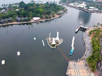 High angle view of river amidst trees in city