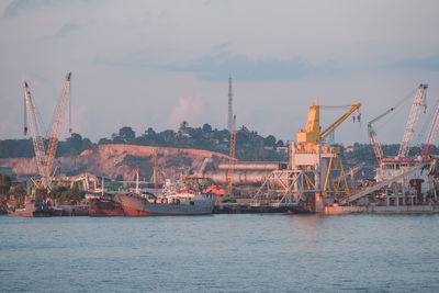 Commercial dock by sea against sky