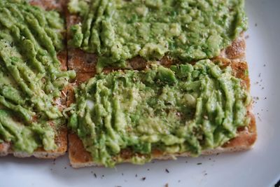 High angle view of crispbread with avocado served in plate