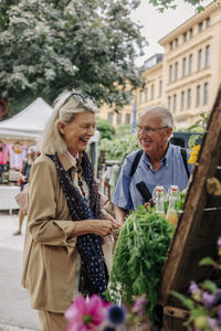 Happy senior couple at farmer's market in city